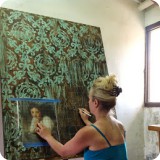 Heather situates where she would like to place the figure on the faux background, and works on sketching it to a scale.