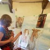 Lori LeMare and Heather Kent critiquing her whimsical twist on a classic Botticelli painting...inspired by Luna the goat who lived in the monastery garden.