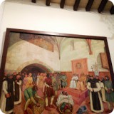 A large painting donated to Sant Jeroni depicts Christopher Columbus meeting with the King and Queen of Spain, who funded his explorations.