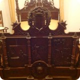 The King's bed detailing includes a carved wood footboard depicting the voyage of Christopher Columbus.