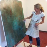 Lori working character into her copper patina background.