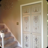 53  Hand-painted ornamental detailing on foyer closet doors