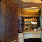 172  Embossed leather walls in a dining room.  Etched fireplace surround mirror panels to coordinate with wall finish.