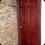 15  Faux bois door finish to complement brick feature wall in a law office - originally door was old, chipped paint