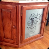 36  Etched family monogram for last name in glass panel & frosted effect via etching concealed contents of television stand.