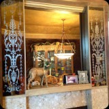 25  Custom ornamental etched mirror panels on dining room fireplace surround.