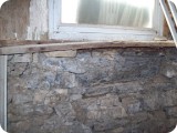 Detail of interior rotted sill where a large chunk of mortar and stone had given way.  It was precariously supported by a few dry stacked stones that crumbled to the touch.  The entire interior needed to be repaired, and was tended to after the exterior work was completed.