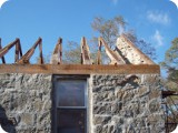 The original timber framing was reinforced with new 2 x 4's to help support the old sagging, rotted roof until it could be replaced.  Didn't dare take the roof off until the stone walls had been repaired and secured, for fear they would fall apart like a house of cards!