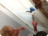 Aunt Dixie painting the bathroom door...with Miss Tillie supervising.
