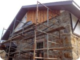 The cedar plank should patina over time to blend well with the original stone walls, & complement the character of the rustic facade.