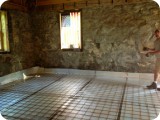 Wire mesh layered on insulation vapor barrier - over what was originally a dirt floor substrate with hand-hewn beams & floor boards.  Heather salvaged/stored the original wood - to be repurposed for stairs, beam accents, etc.