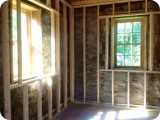 New framing for walls & window sills layered over the original stone walls & hand-hewn ceiling beams.